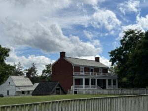 The McLean House with the log shed that served as an icehouse.